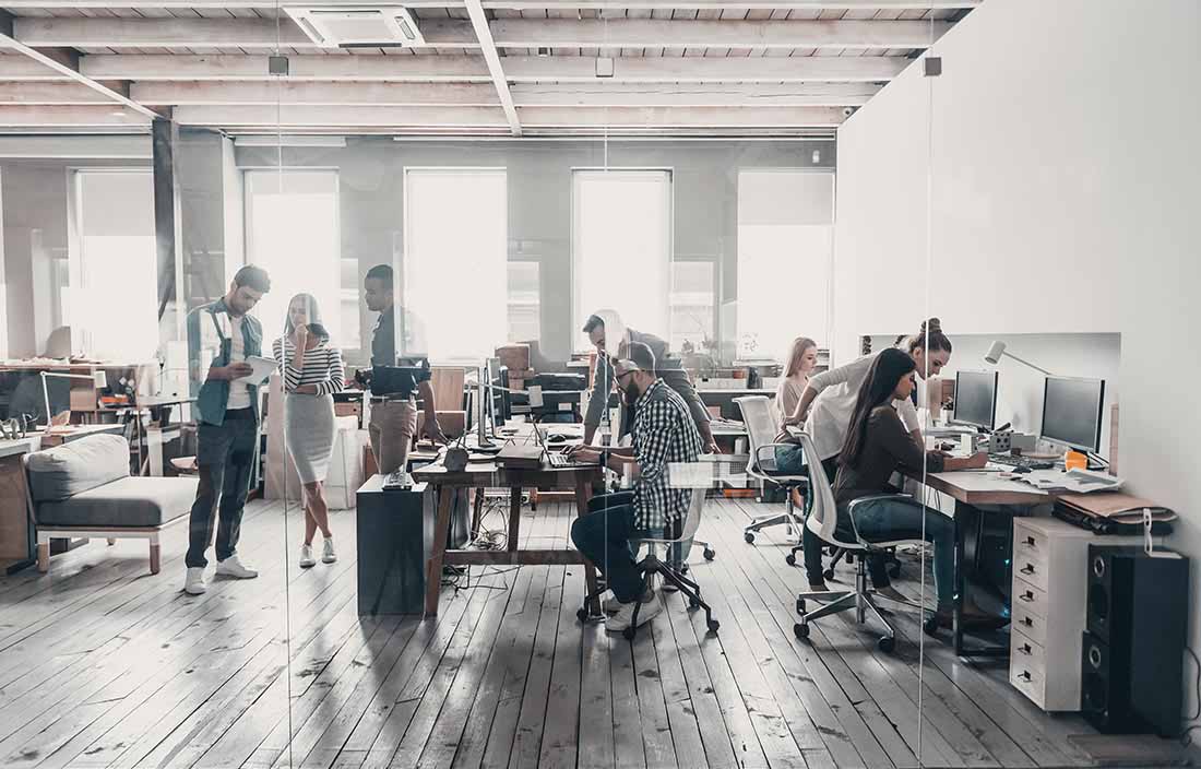 Open office with many workers collaborating